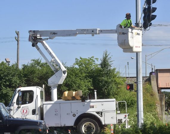 Tribune photo by Aaron Piper / Michiana Contracting Inc. Crews replace the traffic lights at Community Drive and Tipton Street.